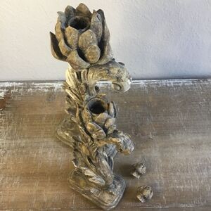 Classic candlesticks with finials to hide candle hole on a base with scrolls